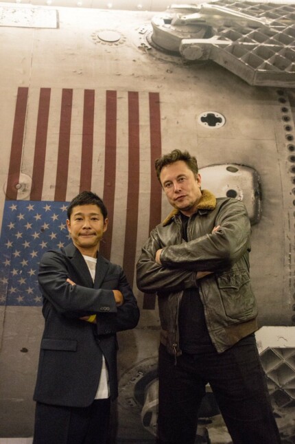 Elon with Yusaku ZOZO founder in front of Booster sticker